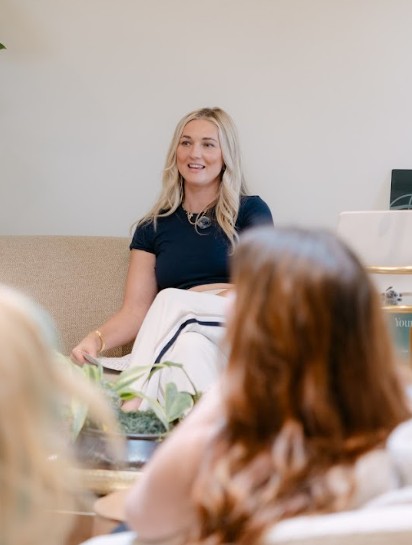 Cheyanne speaking with clients at a wellness event